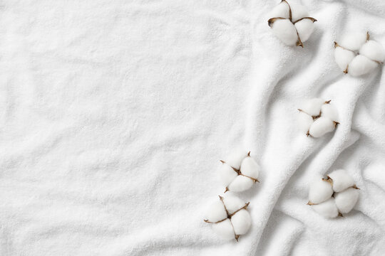 Cotton balls on a white terry towel with copy space.