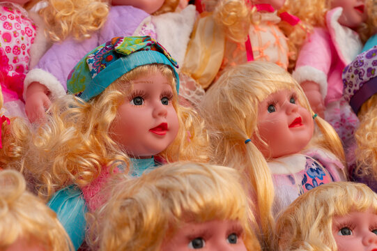 Colourful tiny blonde baby dolls for sale at retail shop at Christmas market, New Market area, Kolkata, West Bengal, India.