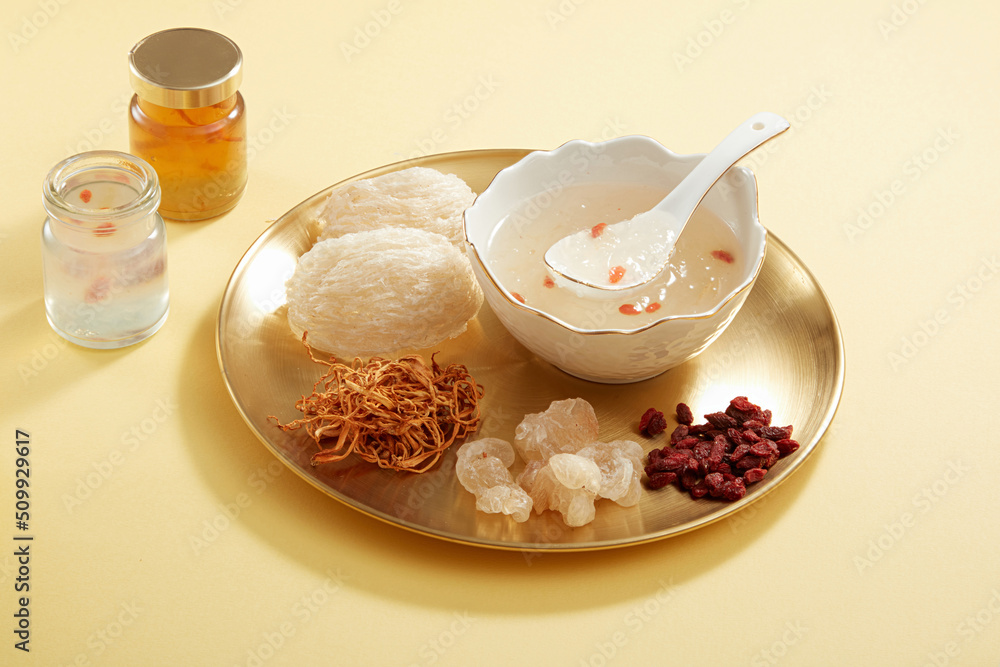 Wall mural front view of birdnest bowl with goji berry with cordycep in yellow table