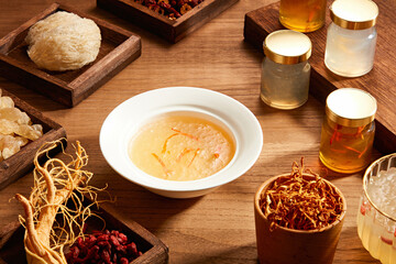 Front view of birdnest bowl with goji berry with cordycep in wooden table background  