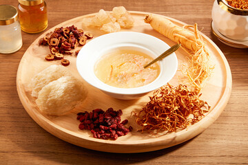 Front view of birdnest bowl with goji berry with cordycep in wooden table background  