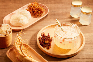 Front view of birdnest bowl with goji berry with cordycep in wooden table background  