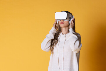 Interactive virtual reality goggles.Asian teen woman wearing VR or Virtual Reality head set for enter to the digital simulation world for learning and traveling or gaming and more.