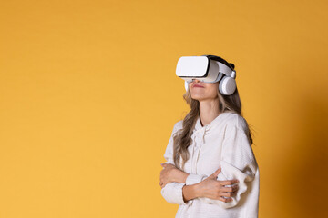 Interactive virtual reality goggles.Asian teen woman wearing VR or Virtual Reality head set for enter to the digital simulation world for learning and traveling or gaming and more.