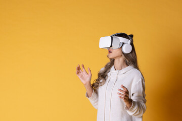 Interactive virtual reality goggles.Asian teen woman wearing VR or Virtual Reality head set for enter to the digital simulation world for learning and traveling or gaming and more.