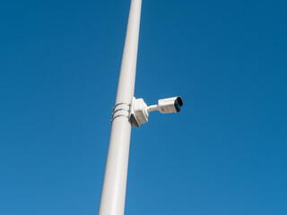 CCTV camera mounted on a pole for street security. Side view