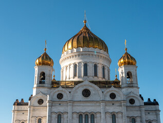 Fototapeta na wymiar Close-up of the Cathedral of Christ the Savior with golden domes against the blue sky. Moscow, Russia