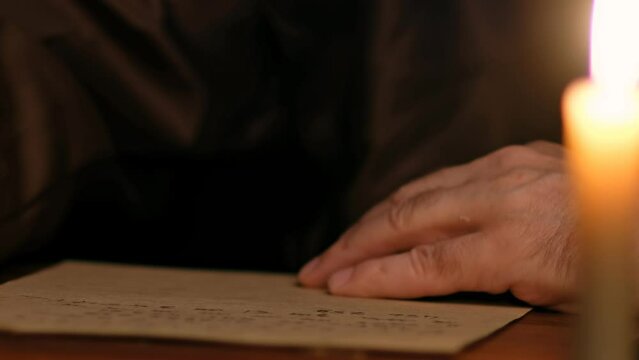 Video of ld monk takes a manuscript out of the document box, signs it, wet paperweight, and puts it back.