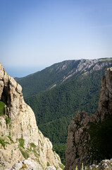 Panorama in a mountainous area in summer. Landscape with mountains, hills and cliffs. Front view.