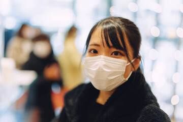 愛知県名古屋市のお店で行列に並ぶマスクの若い女性 Young woman in mask...