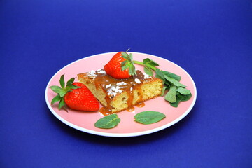 piece of cake with white fondant and red strawberry. on the plate. Confectionery, cakes. food. sweet concept.	