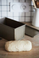 The process of making homemade toast bread in a mold. The concept of healthy homemade food. Vertical photo.