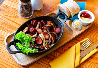Spicy fried sausages with onions served with butter, sauces and fresh greens. Typical polish dish