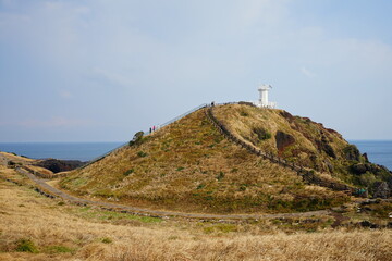 Fototapeta na wymiar lighthouse and seaside walkway
