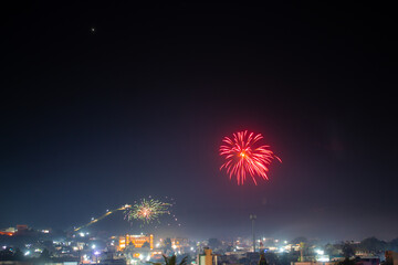 Wide angle shot of fireworks above the city during the 4th of July celebration . Celebration background. Fireworks in the sky above the city, Celebration background. Background of city with firework