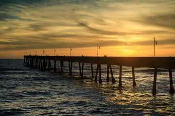 Fototapeta na wymiar Sunset over Pacifica Municipal Pier. Pacifica, San Mateo County, California, USA.