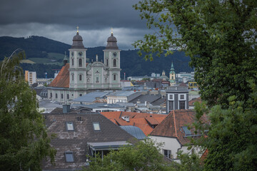 Green church with twin towers in Linz, Upper Austria, Skyline of Linz with old twin tower church as...