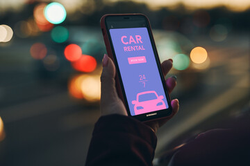 Woman renting car online using mobile app on smart phone. Person booking car using mobile...