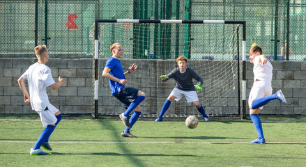 Teens playing soccer football match. Competition between two youth soccer teams. Football soccer...