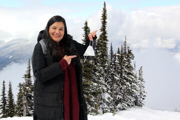 Latin adult woman arrives in Canada and discovers the snowy mountains with a face mask due to the...