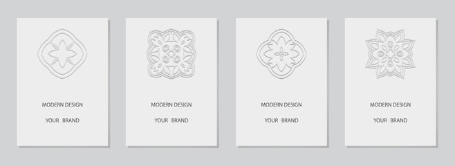 Naklejka premium Cover set, vertical templates. Collection of white backgrounds with 3d relief pattern. Ethnic logo, monogram, emblem in the traditional style of the peoples of the East, Asia, India, Mexico, Aztecs.