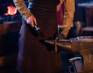 blacksmith makes a product from iron in the forge