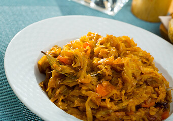 Tasty vegetarian dish - braised cabbage with carrot served on plate