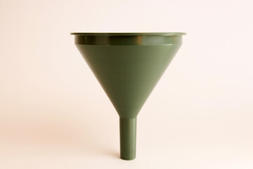 Green plastic watering can on a white background.