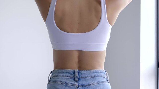 A woman showing her slim waist. Beautiful slim woman body in