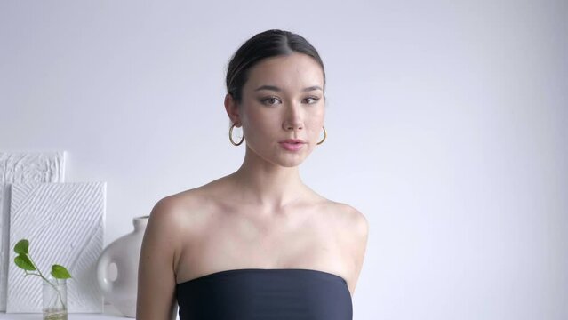 An Attractive Person In Dark Strapless Undergarment. Medium Close-up Shot