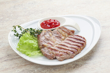 Grilled pork neck steak with ketchup