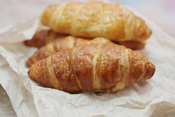 Delicious fresh croissants arranged on a plate