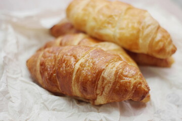 Delicious fresh croissants arranged on a plate