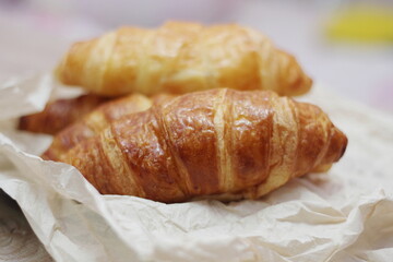 Delicious fresh croissants arranged on a plate