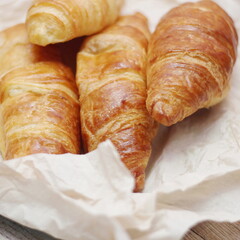 Delicious fresh croissants arranged on a plate