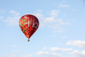 Colorful hot air balloon flies in the sky in good weather