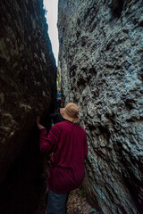 Naklejka premium One of the hiking trails to the top of the ancient volcano Nglanggeran, Indonesia, there is a narrow passage of 2 large cliffs that must be passed to get to the top