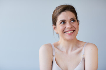 Smiling woman with naked shoulders. Long hair and short hair dress.