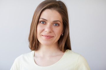 Smiling woman close up face portrait. Girl looking away. Female head shot with shallow depth of field.