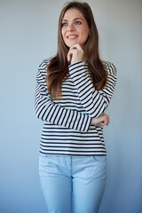 Smiling woman dressed casual clothes looking away. isolated portrait of young woman.