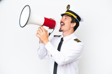 Airplane caucasian pilot isolated on white background shouting through a megaphone