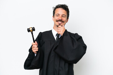 Naklejka premium Young judge caucasian man isolated on white background looking to the side and smiling
