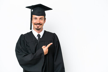 Young university graduate man isolated on white background pointing to the side to present a product