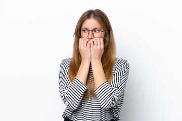 Fototapeta premium Young caucasian woman isolated on white background nervous and scared putting hands to mouth