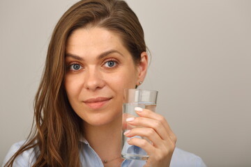 Face of smiling woman drinking water close up portrait isolated.