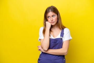Young caucasian woman isolated on yellow background with tired and bored expression