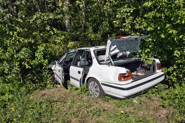 Abandoned car on the roadside forest after accident