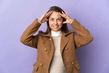 Middle age Brazilian woman isolated on purple background with surprise expression