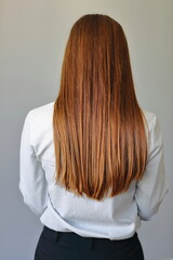 Naklejka premium Woman with long brown hair standing back.