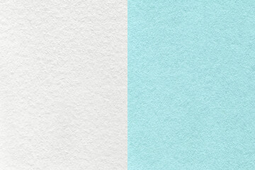 Fototapeta premium Texture of craft blue and white paper background, half two colors, macro. Structure of vintage cerulean cardboard.